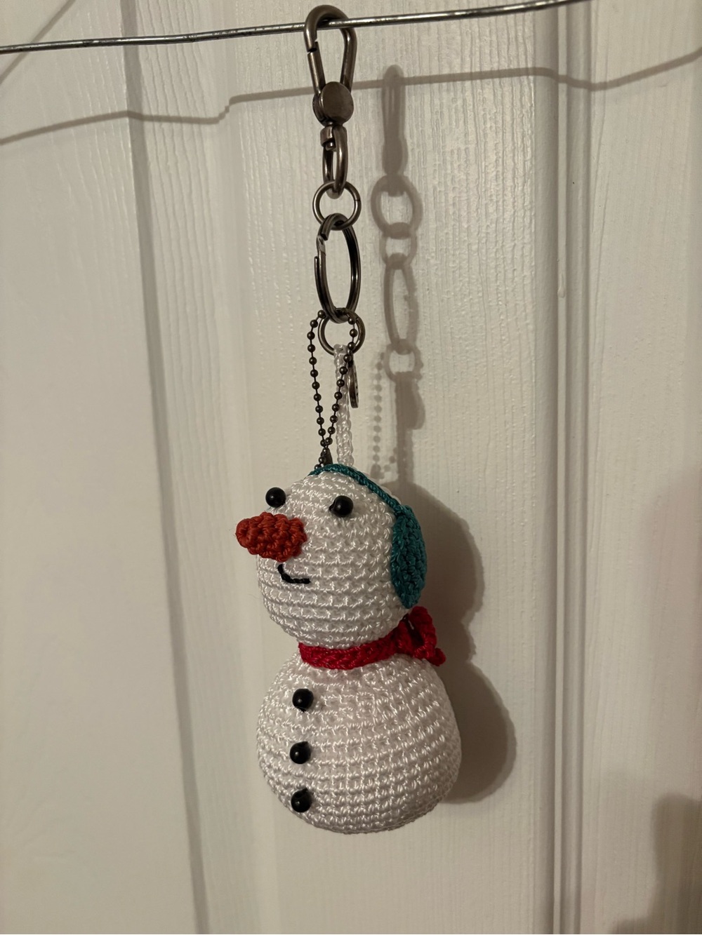The Sak Crochet Yarnicharmz Snowman Keychain in White, Red, Teal